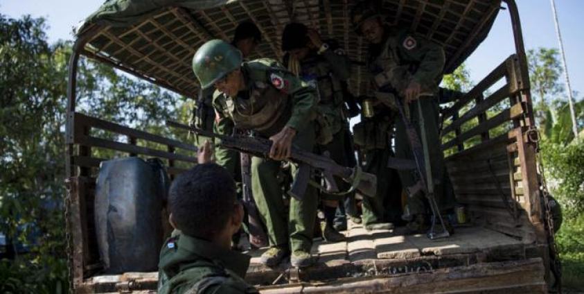 (File) Myanmar soldiers arrive as they bring the residents displaced from the conflict between a group of armed Muslim militants and government troops, to take refuge at a Buddhist monastery in Maungdaw located in Rakhine State near the Bangladesh border on October 15, 2016. Photo: Ye Aung Thu/AFP