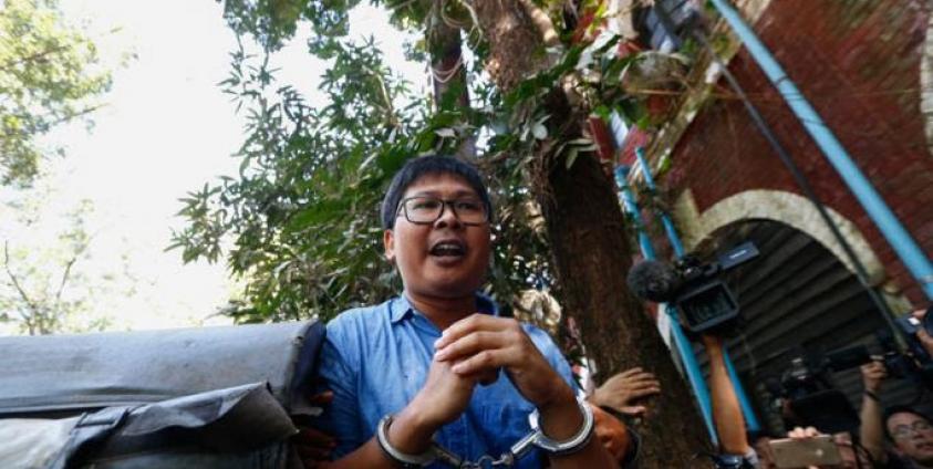 (File) Reuters' journalist Wa Lone in handcuffs talks to the media as he leaves the court after the first trial in Yangon, Myanmar, 10 January 2018. Photo: Lynn Bo Bo/EPA