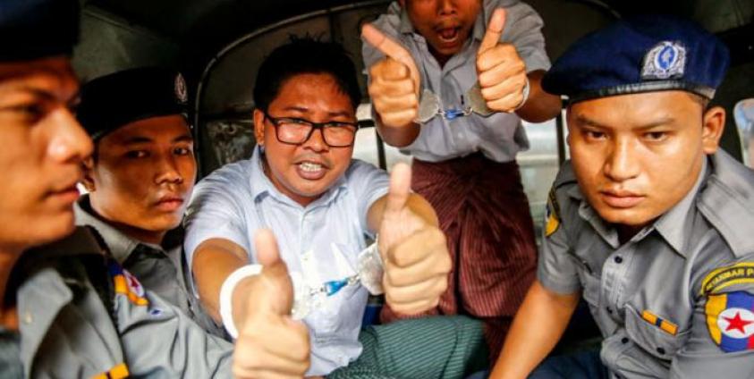 (FILE) - Reuters journalists Wa Lone (3-L) and Kyaw Soe Oo (2-R) gesture as they prepare to leave the Insein township court in a van, in Yangon, Myanmar, 03 September 2018. Photo: Lynn Bo Bo/EPA