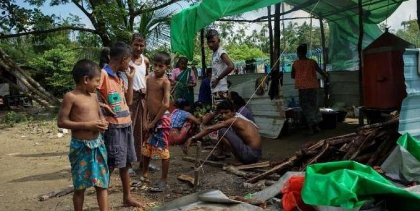 This photo taken on Sept 22, 2017 in Sittwe, in Myanmar's Rakhine state, shows boys waiting for food near a makeshift kitchen outside a disused football stadium in an IDP camp sheltering hundreds of Hindu villagers displaced by communal violence. Photo: AIDAN JONES / AFP