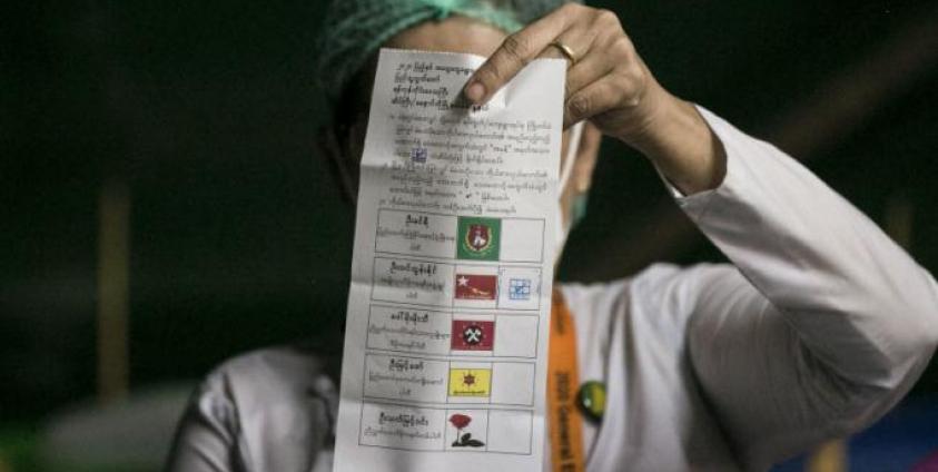 An election official counts a ballot after the polls closed at a polling station in Yangon on November 8, 2020. Photo: Sai Aung Main / AFP