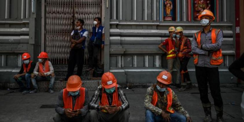 Construction workers gather during a protest to demand recognition of their labour rights, as some said they did not receive their full wages, in Yangon. Photo: AFP