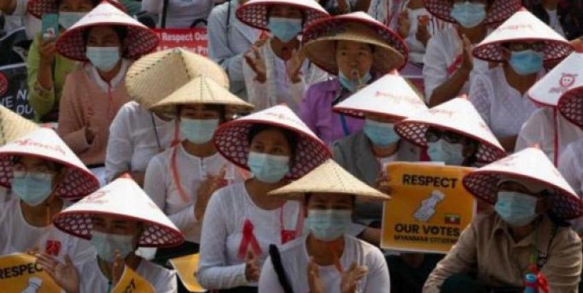 Myanmar women in traditional hat occupy a street during a demonstration against the military coup in Mandalay. Photo: AFP