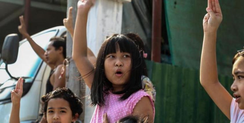 Children flash the defiant three-finger salute as demonstrators march during an anti-military coup protest in Mandalay, Myanmar. Photo: EPA