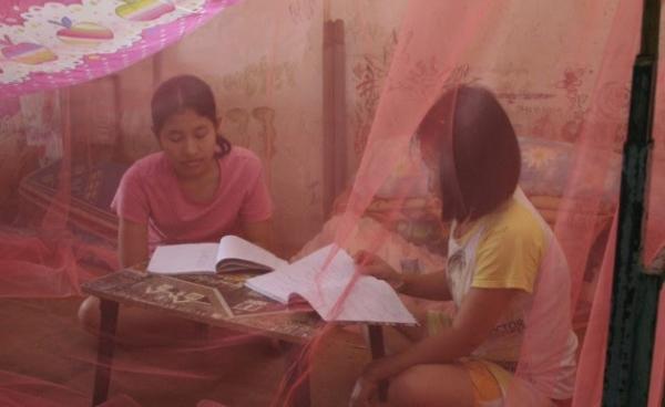 Students are studying inside the mosquitos Net donated by Ms. Gale, BCTFN, at school dormitory - Photo by Aya Tabata