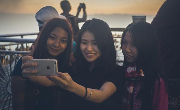 Tourists take a selfie at the Golden Rock. Photo: Ernest Chan