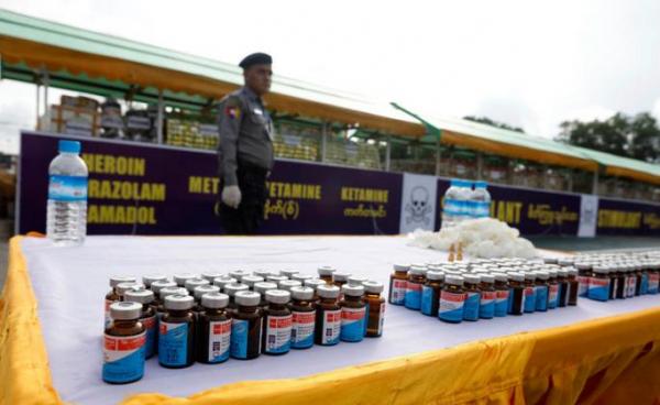 A Myanmar police officer stands near a pile of illegal drugs during a 'Destruction Ceremony of Seized Narcotic Drugs', held to mark the International Day against Drug Abuse, in Yangon, Myanmar, 26 June 2019. Photo: Nyein Chan Niang/EPA