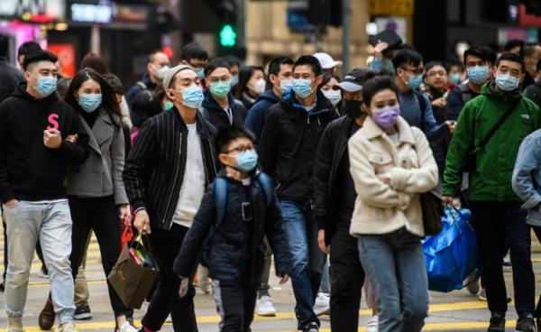 Bangkok Post | Pedestrians wearing face masks cross a road during the Lunar New Year of the Rat public holiday in Hong Kong on Jan 27 as a preventative measure following the coronavirus outbreak which began in the Chinese city of Wuhan.