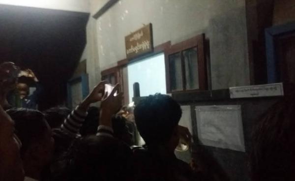 Spectators take photos of a list displaying election results for Taunggyi Township. 