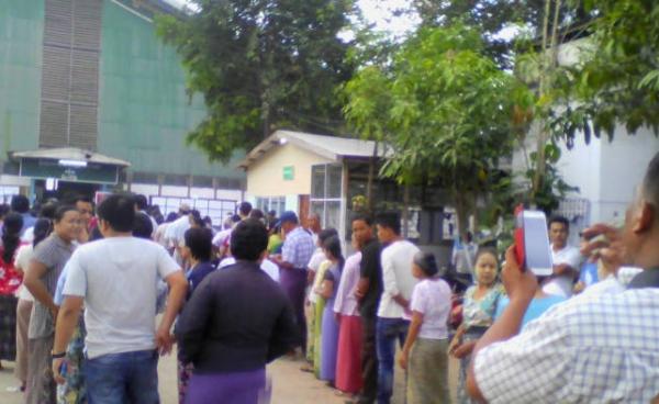 People wait for the arrival of late ballot boxes in a ward in Myawaddy, Karen State.