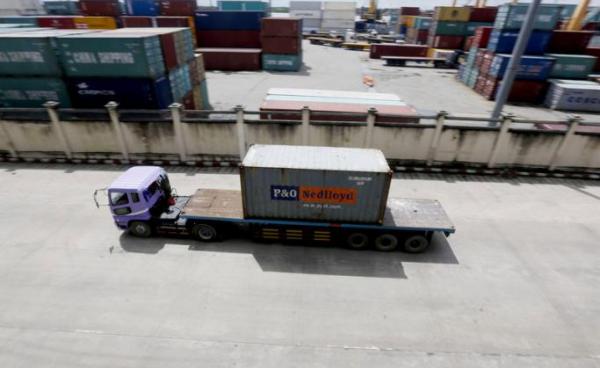 A truck carries a container at the Ahlone international terminal port in Yangon. Photo: EPA