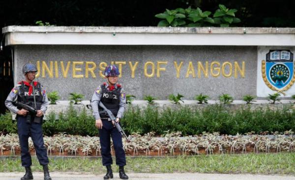 Armed police officers stand guard in Yangon. Photo: EPA