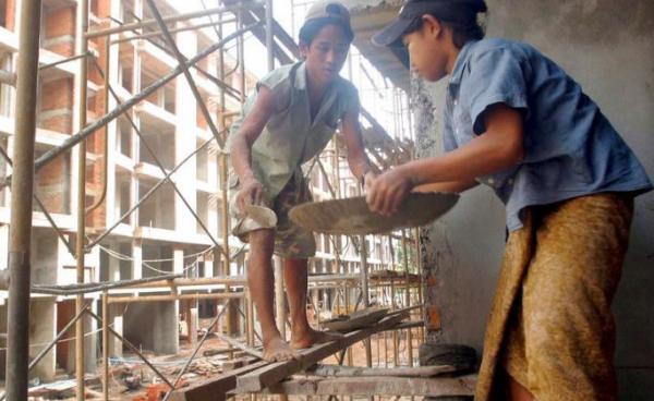 Child construction workers at work on a building site in Yangon. Photo: EPA