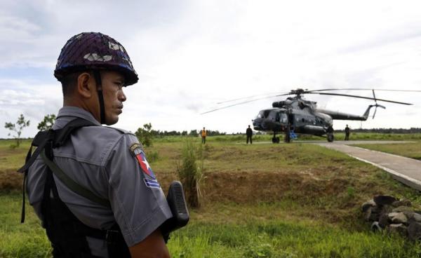 Police stands guard near the military transport helicopter at Maungdaw township in Rakhine State, western Myanmar, 27 September 2017. Photo: Nyein Chan Naing/EPA