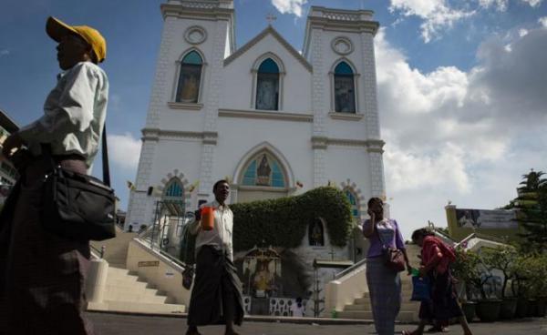 Catholics from Myanmar walk in front of St. Anthony Church in Yangon. Photo: AFP