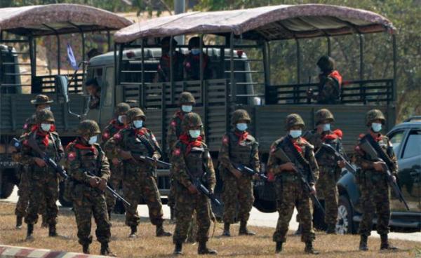 Soldiers stand guard as they block a road near a prison in Naypyidaw on February 15, 2021, after the military seized power in a coup. Photo: AFP