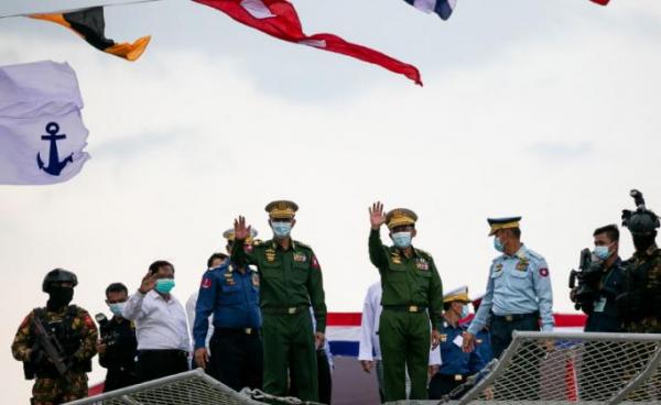 Myanmar armed forces chief Senior General Min Aung Hlaing (4th R) waves during the inauguration of a new military coastguard in Yangon on October 6, 2021. STR / AFP