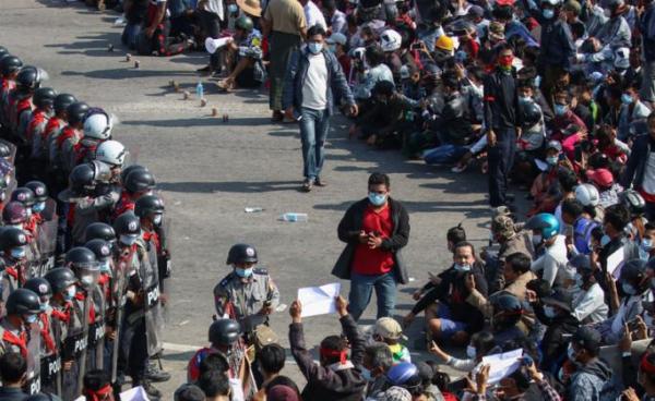 BBC correspondent Aung Thura (top, C-L) and Mizzima journalist Than Htike Aung (C-R) walk among demonstrators during a protest in Naypyidaw, 08 February 2021. - EPA