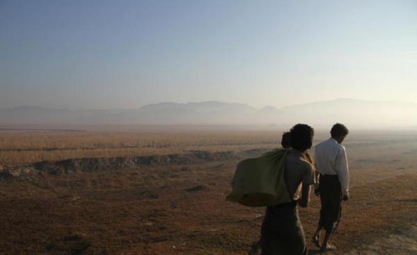 Three people walk along a road in Buthidaung township, Rakhine State. Photo: Richard Sargent/AFP