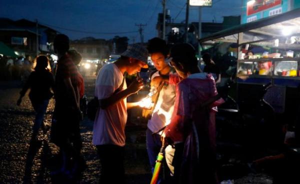 A buyer checks a Jade stone at the LoneKhin night market in Hpakant, Kachin State, northern Myanmar. Photo: Nyein Chan Naing/EPA