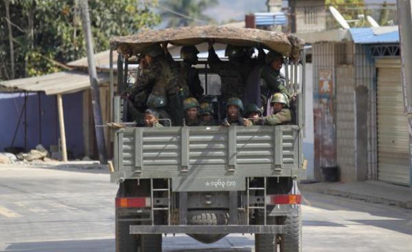 (File) Military truck loaded soldier passes along a deserted road at self-administered Kokang capital Laukkai, northern Shan State, Myanmar, 17 February 2015. Photo: Lynn Bo Bo/EPA