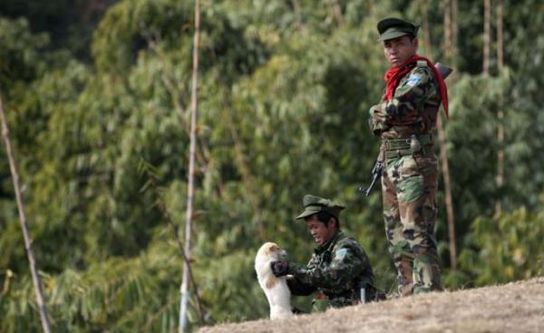 Taaung National Liberation Army (TNLA), a Palaung ethnic armed group, standing guard outside a village in Mantong township, in Myanmar's northern Shan state. Photo: Ye Aung Thu/AFP