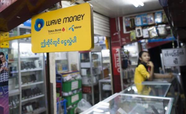 A signboard for mobile banking firm Wave Money at a telecommunications shop in downtown Yangon. Photo: AFP