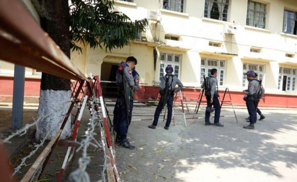 Armed police officers stand guard near Sittwe Court. Photo: Nyunt Win/EPA