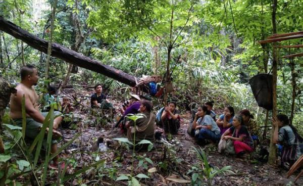 This handout from Karen Medical Information received on May 7, 2021 shows a medical staff member talking to internally displaced people in Karen State, following air strikes in the area by the Myanmar military after the February 1 coup. Photo: KAREN MEDICAL INFORMATION/AFP