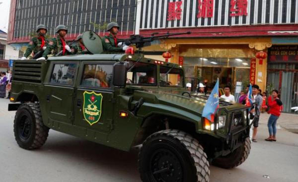 An armored fighting vehicle of the United Wa State Army (UWSA) drives in a downtown area of Panghsang, also called Pang Kham, autonomous Wa region, north-eastern Myanmar, 17 April 2019. Photo: Lynn Bo Bo/EPA