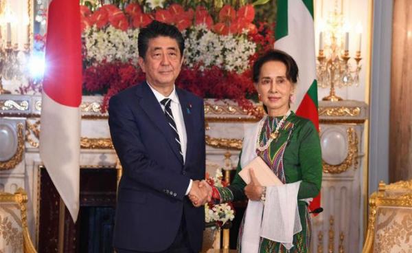 State Counsellor Daw Aung San Suu Kyi shakes hands with Prime Minister of Japan Mr Shinzo Abe at the State Guest House in Tokyo, Japan yesterday. Photo: MNA