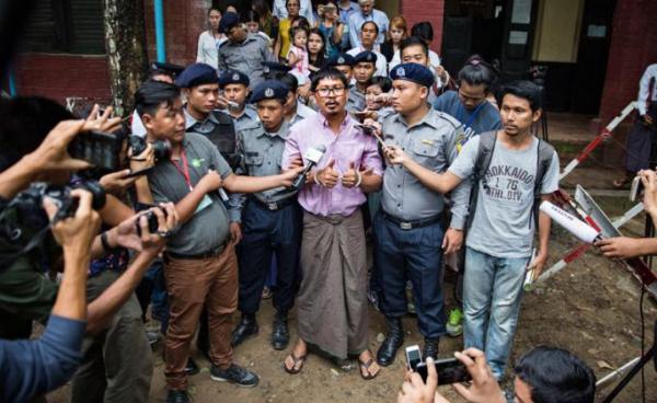 (File) Detained Reuters journalist Wa Lone (C) talks to media while being escorted by police as he leaves the court after his trial hearing in Yangon, Myanmar, 02 July 2018. Photo: Lynn Bo Bo/EPA