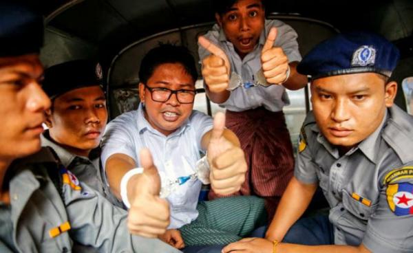 (FILE) - Reuters journalists Wa Lone (3-L) and Kyaw Soe Oo (2-R) gesture as they prepare to leave the Insein township court in a van, in Yangon, Myanmar, 03 September 2018. Photo: Lynn Bo Bo/EPA