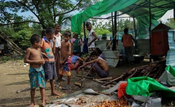 This photo taken on Sept 22, 2017 in Sittwe, in Myanmar's Rakhine state, shows boys waiting for food near a makeshift kitchen outside a disused football stadium in an IDP camp sheltering hundreds of Hindu villagers displaced by communal violence. Photo: AIDAN JONES / AFP