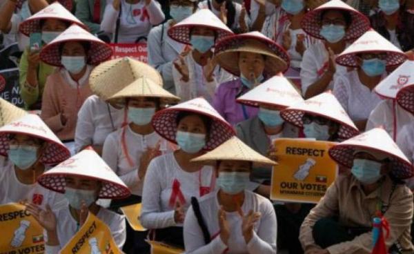 Myanmar women in traditional hat occupy a street during a demonstration against the military coup in Mandalay. Photo: AFP