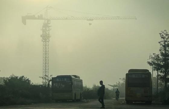 A man crosses a street amid high levels of air pollution in Yangon on January 27, 2025. (Photo by Sai Aung MAIN / AFP)