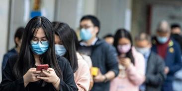 People queue outside a pharmacy as they won the lottery to buy protective masks, in Guangzhou, China, 13 February 2020. Photo: EPA